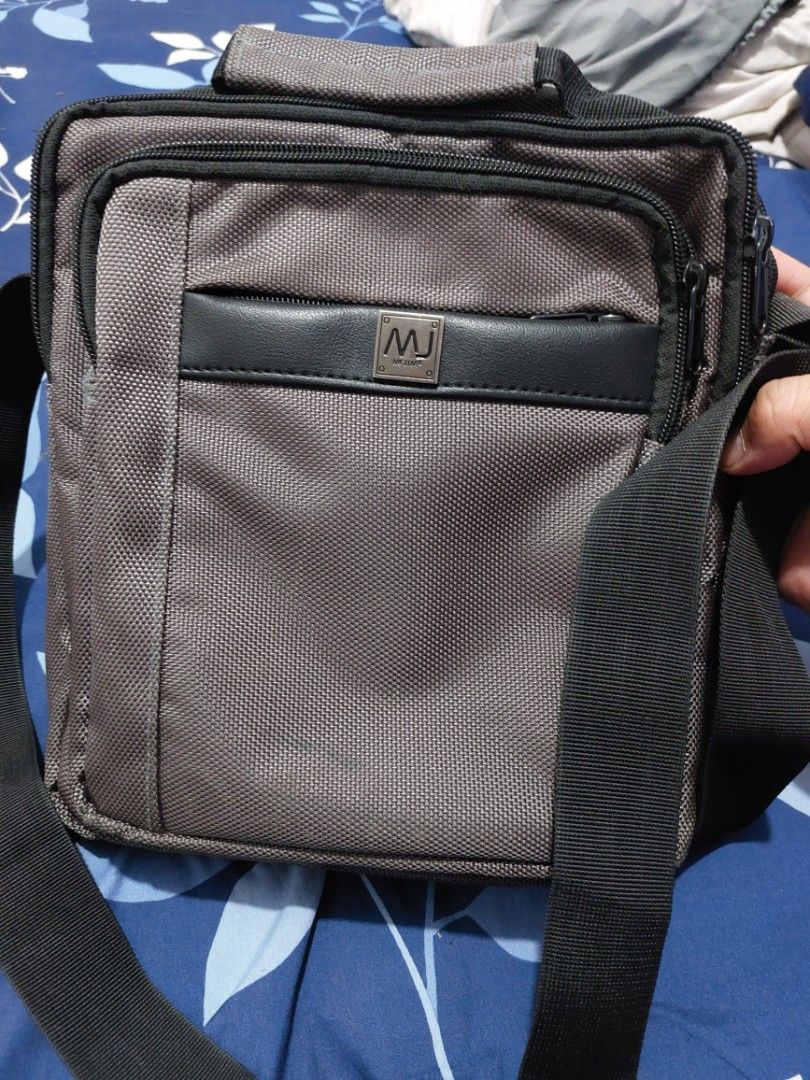 MJ Messenger Bag (Category: Cross-body Bags) located in Manila. Submitted by lhapogs (Listing ID 1464473499, Image 1). Description: 500 nalang manila area - Grey MJ messenger bag - Features multiple compartments for organization - Adjustable strap for comfortable carrying - Ideal for daily use or travel - Clean and ready for a new owner.