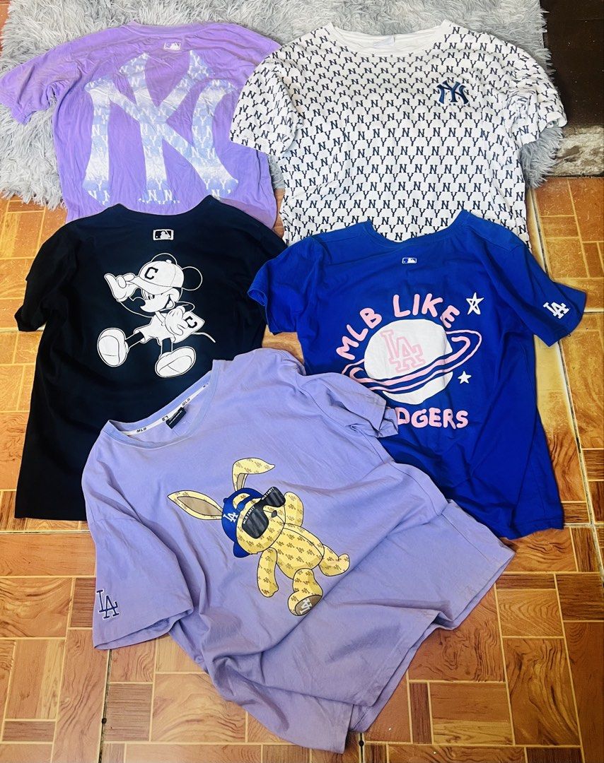 MLB New York Yankees & LA Dodgers T-Shirts Bundle (Category: Tshirts & Polo Shirts ) located in Manila. Submitted by zealocean.1db413 (Listing ID 1464364197, Image 1). Description: Aspak 1200 - Bundle of 4 graphic tees - Includes 2 New York Yankees shirts (one with a large logo, one all-over print) - Features a blue LA Dodgers shirt with a planet graphic - Comes with a purple tee showcasing a cool bunny graphic - Ideal for everyday casual wear.