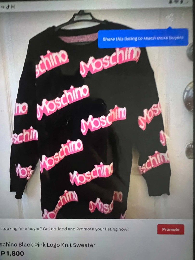 Moschino Black Pink Logo Knit Sweater (Category: Longsleeves) located in Manila. Submitted by supermom888 (Listing ID 1464367683, Image 1). Description: - Black knit sweater - All-over pink Moschino logo print - Long sleeves - Crew neck - Great for casual wear - Comfy and stylish.
