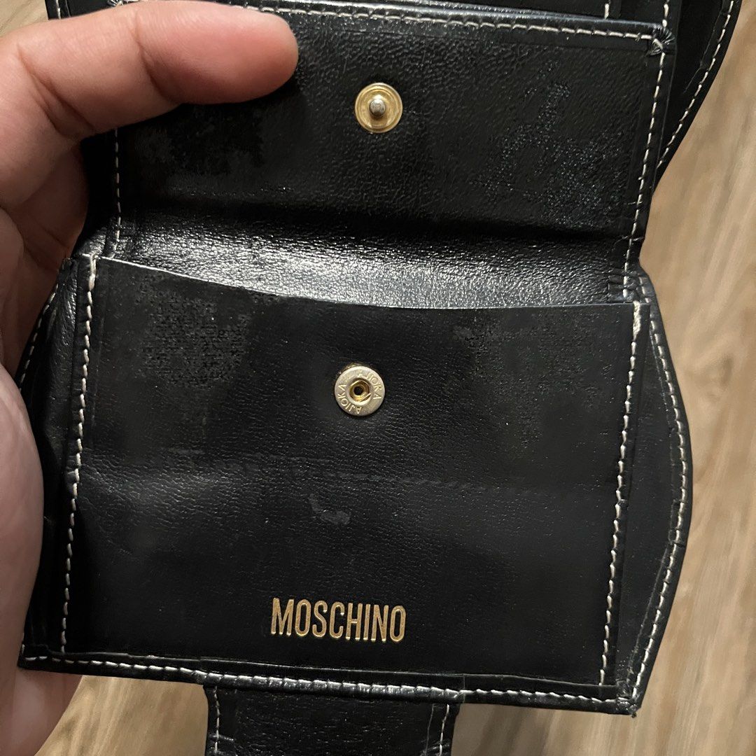 Moschino Heart Bi-fold Wallet (Category: Wallets & Card holders) located in Marikina City. Submitted by wayupcollective (Listing ID 1464416242, Image 3). Description: Moschino Heart Bi-fold Wallet Good as new Signs if usage: scratches at the back and inside Check photos.