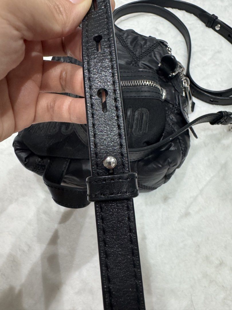 Moschino Milano Quilted Multi Way Bag (Category: Luxury Bags & Wallets) located in San Nicolas. Submitted by ihascat (Listing ID 1464498851, Image 3). Description: - Black quilted Moschino crossbody bag - Flaws: Missing adjustment stud hut still functional -can be shoulder bag or backpack - Iconic Moschino Milano logo on front - Adjustable leather strap - Silver-tone hardware and zipper details - Versatile for everyday or evening use.