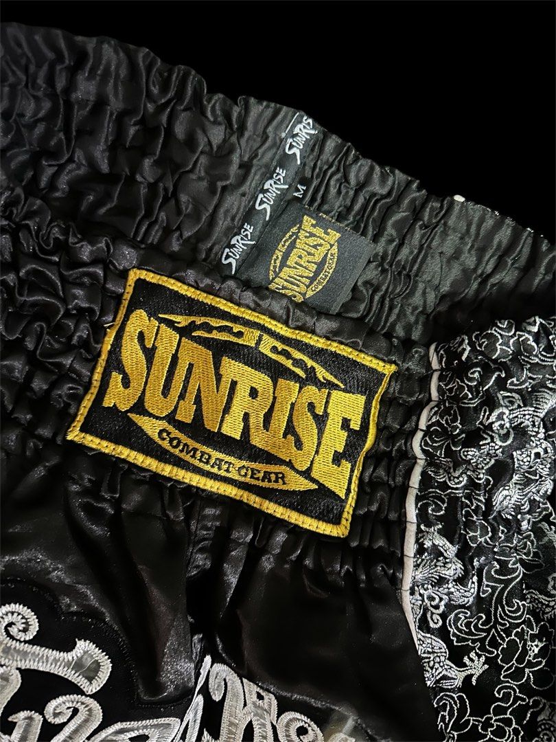 Muay Thai Shorts (medium) (Category: Shorts) located in Mandaluyong City. Submitted by xialeigh (Listing ID 1464439654, Image 3). Description: - Brand: Sunrise Combat Gear - Type: Muay Thai Shorts - Color: Black - Design: Cool dragon pattern on sides and front - Features: Comfortable elastic waistband - Size: Medium (M) - Ideal for: Training and sparring.