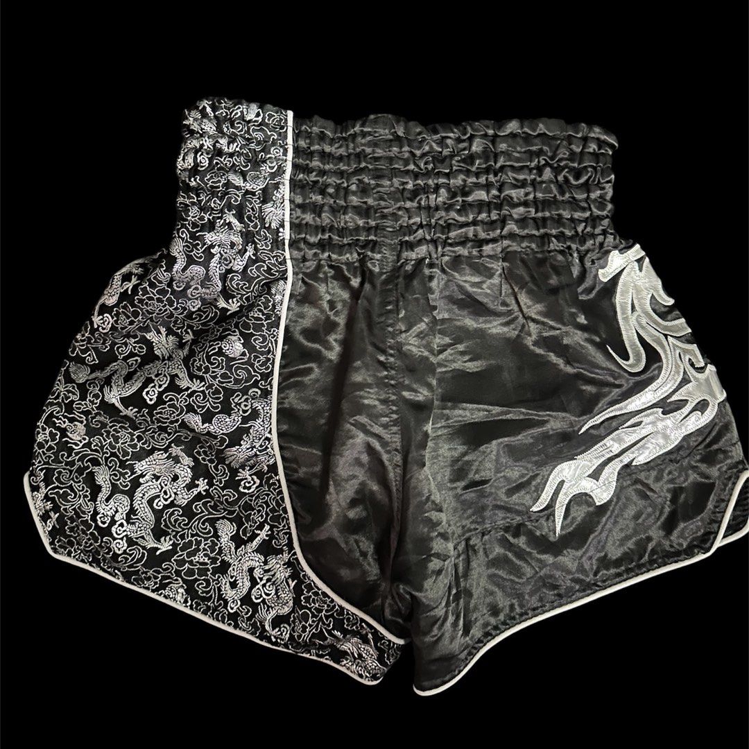 Muay Thai Shorts (medium) (Category: Shorts) located in Mandaluyong City. Submitted by xialeigh (Listing ID 1464439654, Image 2). Description: - Brand: Sunrise Combat Gear - Type: Muay Thai Shorts - Color: Black - Design: Cool dragon pattern on sides and front - Features: Comfortable elastic waistband - Size: Medium (M) - Ideal for: Training and sparring.