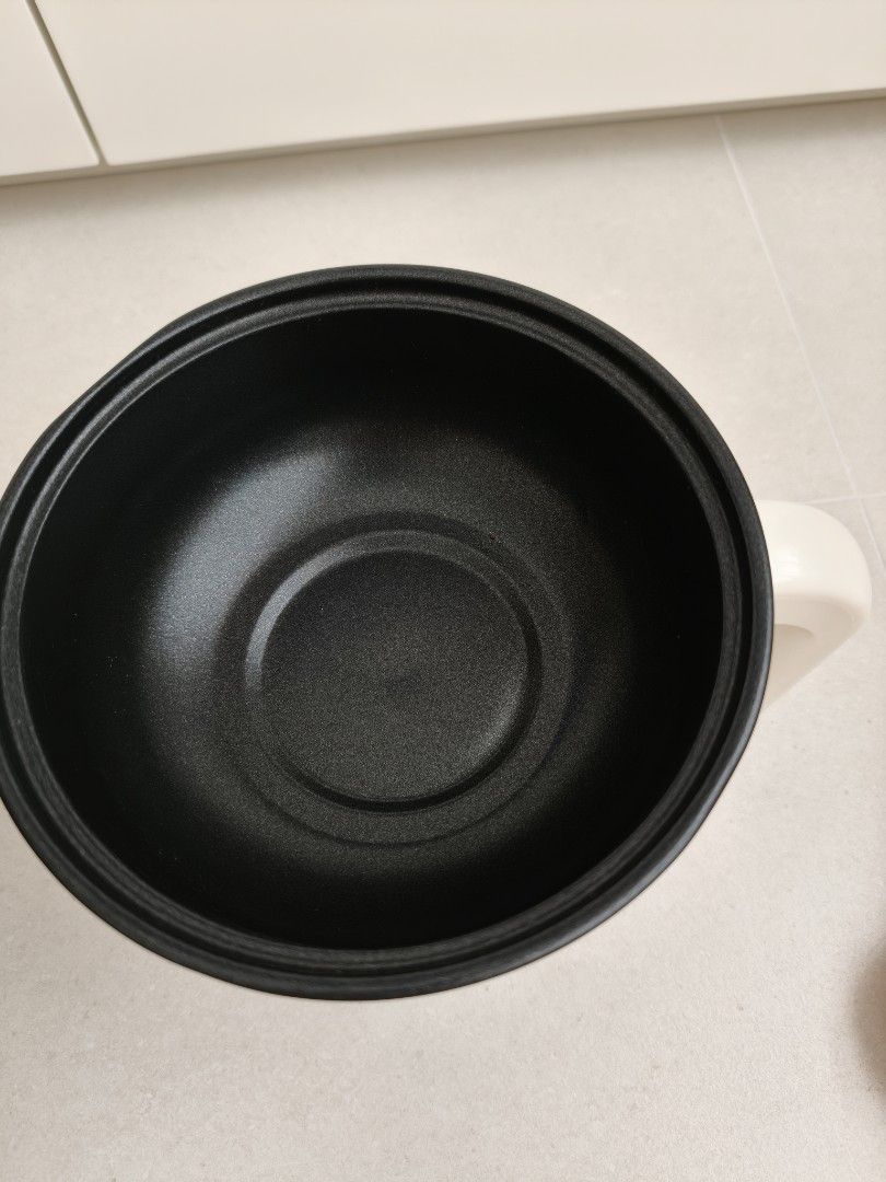 Multi function Electric Pot (Category: Cookware & Accessories) located in Singapore. Submitted by hoo_hah (Listing ID 1464369483, Image 2). Description: - White electric pot - Glass lid with white handle - Black non-stick inner pot - Simple on/off switch - Perfect for cooking small meals or boiling water - Easy to clean.