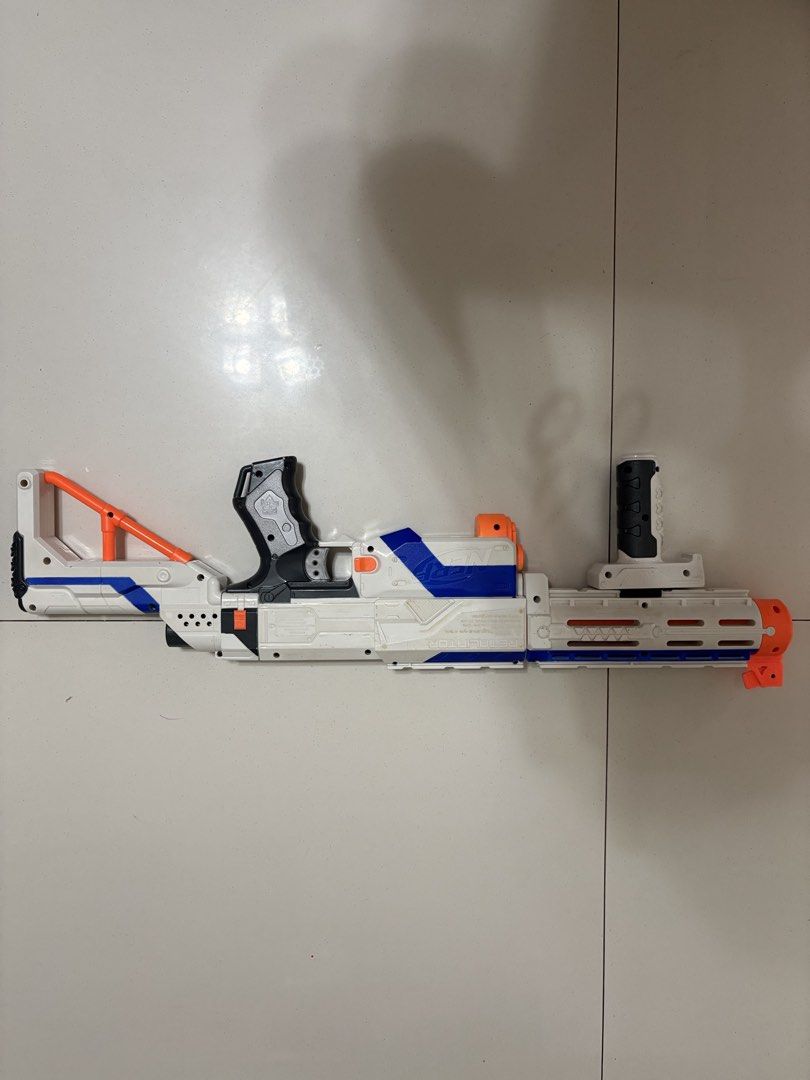 Nerf Elite Retaliator Blaster Toy Gun (Category: Action & Battle Toys) located in Taytay. Submitted by justinqt (Listing ID 1464387515, Image 1). Description: - White and blue Nerf Elite Retaliator blaster - Includes front barrel attachment - Includes stock - Features a removable handle - Great for play or collection - Ready for action!.