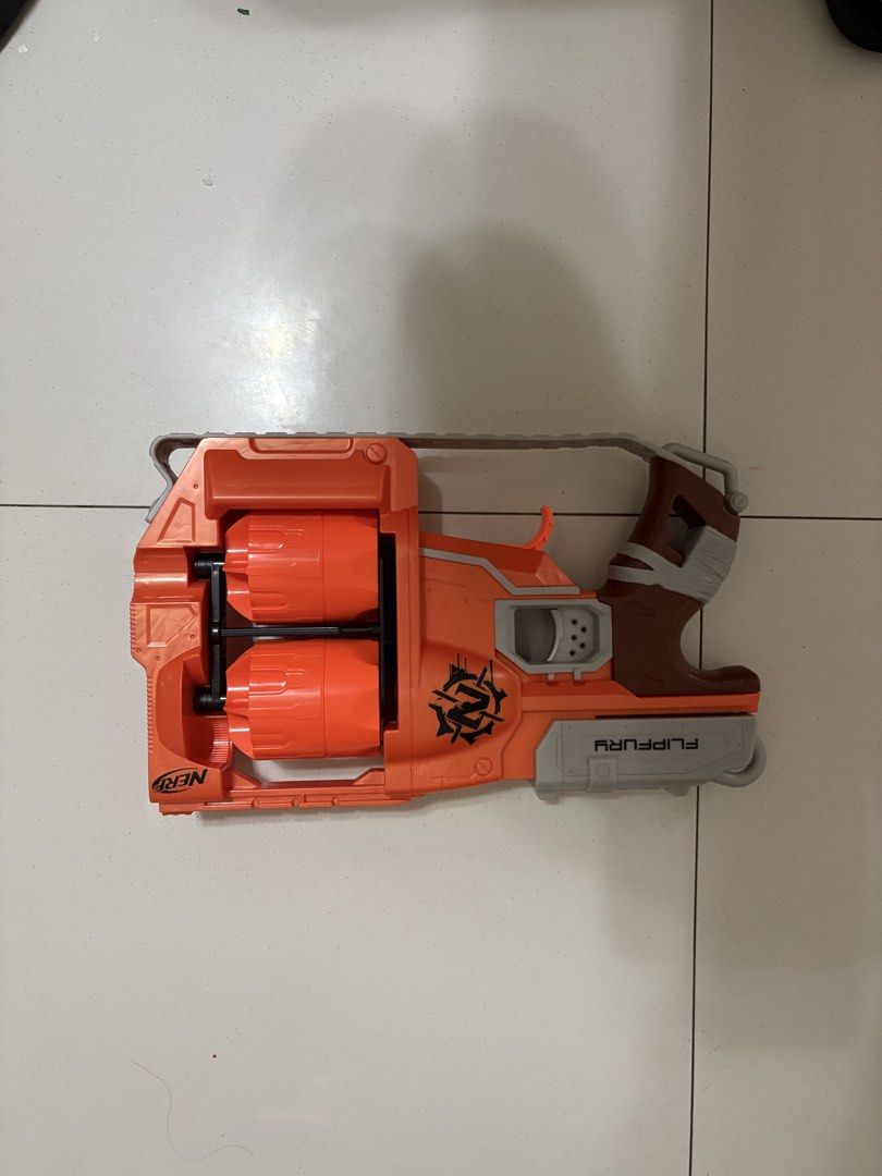 Nerf FlipFury Toy Gun (Category: Action & Battle Toys) located in Taytay. Submitted by justinqt (Listing ID 1464387438, Image 1). Description: - Orange and grey Nerf toy gun - Features two rotating barrels - Perfect for playtime fun - Minor scuff marks visible on the body - Ready for its next adventure!.