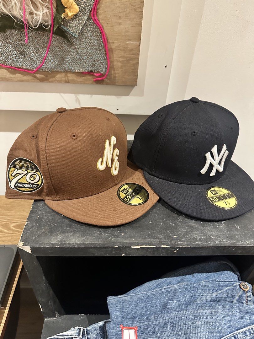 New Era 59FIFTY MLB Baseball Caps - Yankees & NY (Category: Caps & Hats) located in Pasig City. Submitted by erikiii (Listing ID 1464548487, Image 1). Description: - Two authentic New Era 59FIFTY fitted baseball caps. - Black cap features the iconic New York Yankees logo. - Brown cap showcases an 'NY' script and a special 70th Anniversary patch. - Ideal for any dedicated baseball fan or collector..