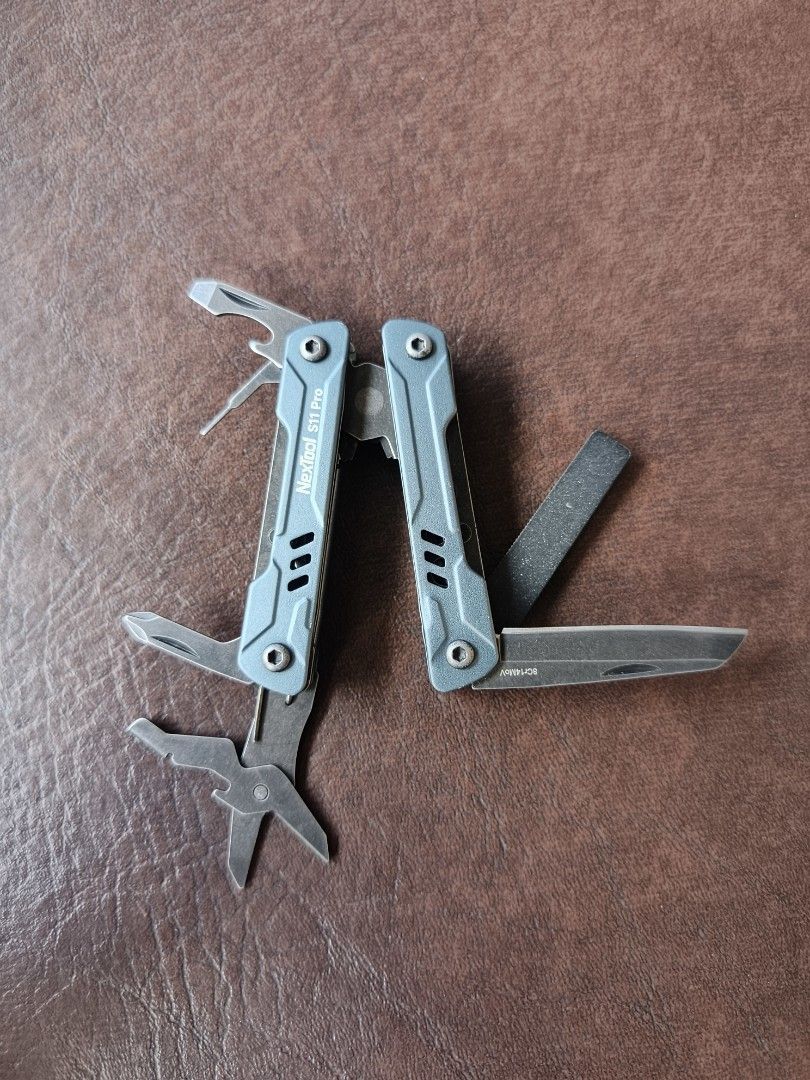 NexTool S11 Pro Multi-tool (Category: Hiking & Camping) located in Manila. Submitted by lean0762 (Listing ID 1464417883, Image 2). Description: - NexTool S11 Pro Multi-tool - Compact and portable design - Durable metal construction - Blue-grey color - Includes pliers, knife, scissors, and other essential tools - Ideal for everyday carry (EDC).
