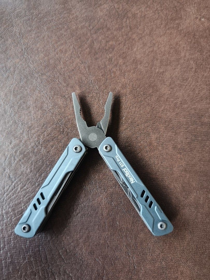 NexTool S11 Pro Multi-tool (Category: Hiking & Camping) located in Manila. Submitted by lean0762 (Listing ID 1464417883, Image 1). Description: - NexTool S11 Pro Multi-tool - Compact and portable design - Durable metal construction - Blue-grey color - Includes pliers, knife, scissors, and other essential tools - Ideal for everyday carry (EDC).