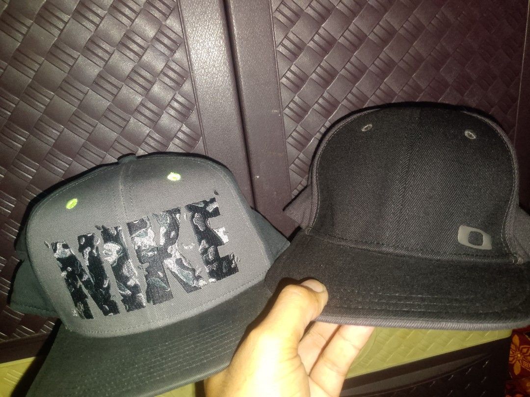 Nike & Oakley Caps Bundle (Category: Caps & Hats) located in Balaoan. Submitted by kulitzz (Listing ID 1464377652, Image 1). Description: - Bundle includes two snapback caps. - Grey Nike snapback features a large graphic logo. - Black Oakley snapback. - Both caps are snapback style. - Ideal for casual everyday wear. - Great value bundle!.