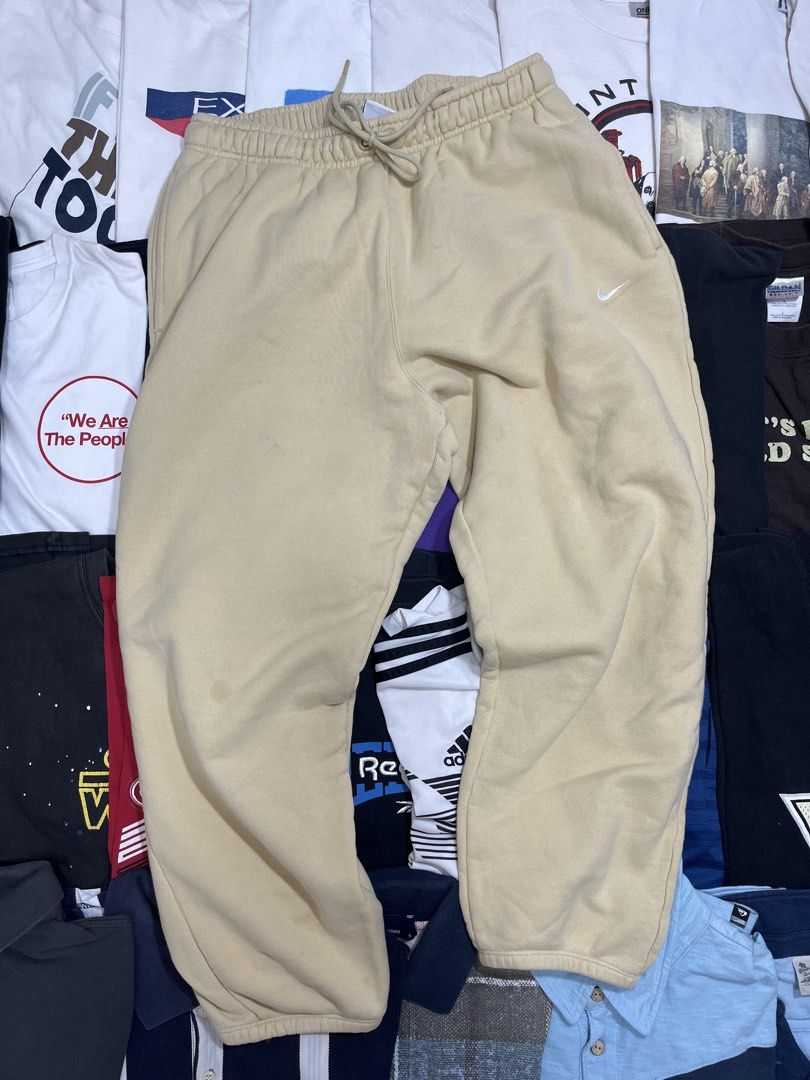 Nike Beige Sweatpants (Category: Joggers) located in Baao. Submitted by plainclothesdept (Listing ID 1464529292, Image 3). Description: Ni/ke Side Swoosh Sweatpants waist - 30-34 in. length - 36 in. thigh - 13 in. hem - 6 in. few stains 950 - Beige Nike sweatpants - Comfortable and casual - Classic embroidered Nike swoosh logo on leg - Drawstring waist for adjustable fit - Minor marks on fabric (please check photos) - Ideal for lounging or everyd