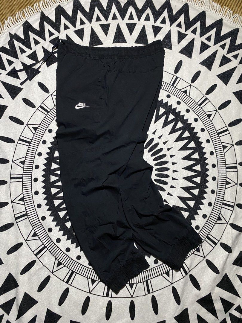 Nike Black Track Pants Joggers (Category: Joggers) located in Badiangan. Submitted by iralorana.thrift (Listing ID 1464466821, Image 2). Description: - Black Nike track pants - Elastic waistband with drawstring - Cuffed ankles - Two side pockets - Simple Nike logo on the left thigh - Ideal for casual wear or sports.