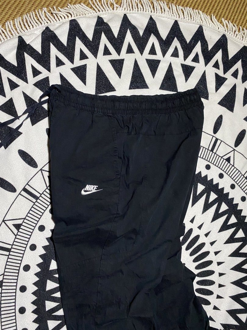 Nike Black Track Pants Joggers (Category: Joggers) located in Badiangan. Submitted by iralorana.thrift (Listing ID 1464466821, Image 3). Description: - Black Nike track pants - Elastic waistband with drawstring - Cuffed ankles - Two side pockets - Simple Nike logo on the left thigh - Ideal for casual wear or sports.