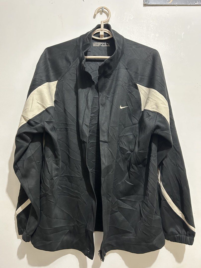 Nike Fit Dry Track Jacket XL Black Beige (Category: Coats, Jackets and Outerwear) located in Calbayog City. Submitted by thrift.bucks101 (Listing ID 1464476751, Image 1). Description: - Black Nike track jacket - Color may vary due to lighting -9.7 color rate - Full zip closure - Nike Dri-FIT material - Size XL - Perfect for workouts or casual wear - Minor creasing from storage.
