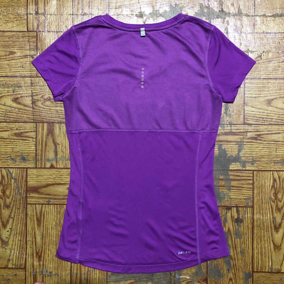 Nike Running Purple Shirt (Category: Shirts) located in Dasmarinas. Submitted by corenyxmessy_3rd_account (Listing ID 1464406468, Image 2). Description: This purple Nike Dri-FIT women’s athletic t-shirt features a reflective silver Swoosh logo on the chest and breathable side panel stitching. width - 16 length - 24.