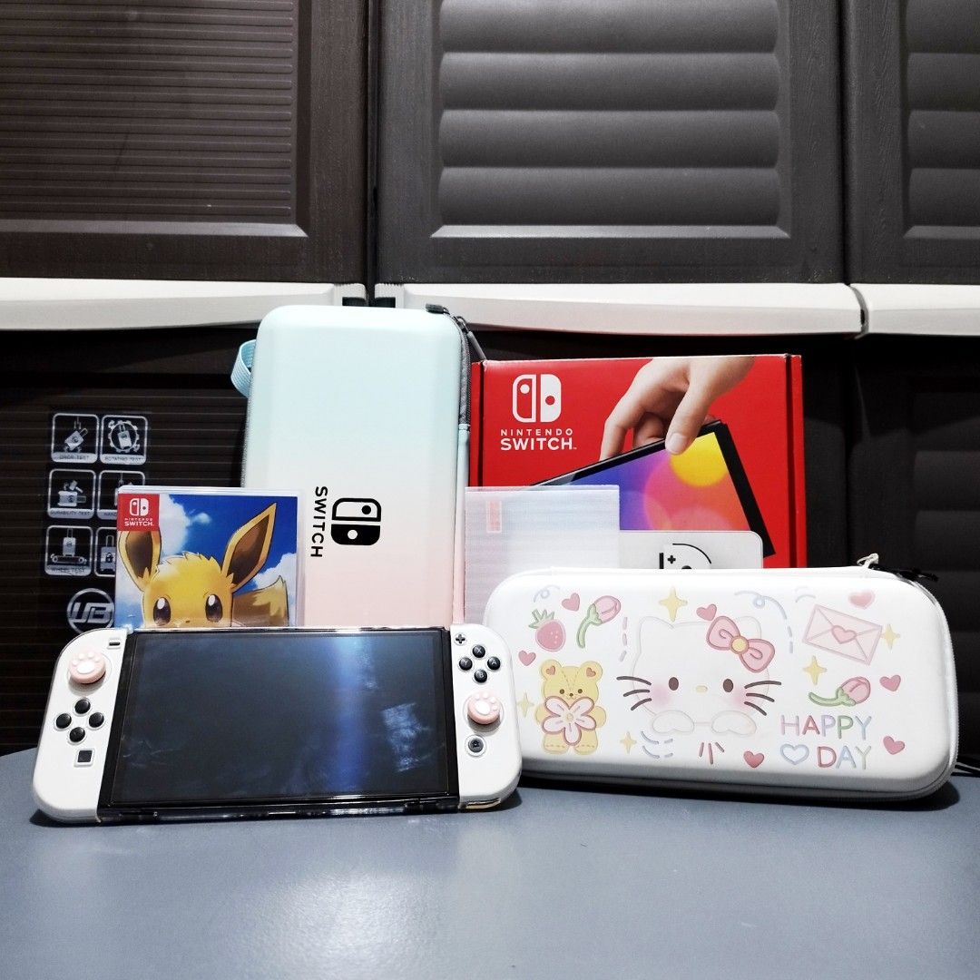 Nintendo Switch Oled (White) (Category: Nintendo) located in Makati City. Submitted by kendrickreovoca (Listing ID 1464522724, Image 1). Description: Nintendo Switch Oled (White) - Good Condition - No Issue - Complete Accessories W Box - Free Physical Game (Pokemon Let's Go Eevee) - W/ Free Accessories Bags & Extra Jelly case and Joycon Rubber - W/ Free Tempered Glass - W/ Free 512Gb Sd Card (if you buy it full price 14k) - Pm for more details.