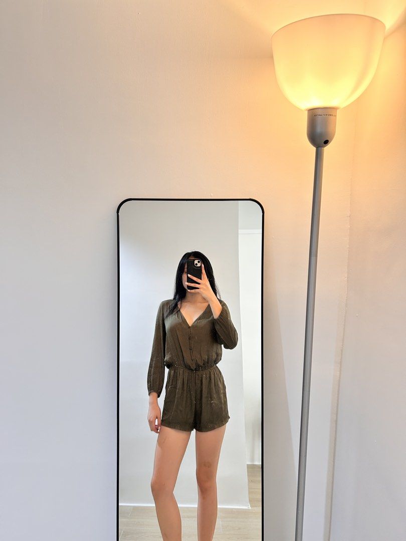 Olive Green Long Sleeve Button Up Romper (Category: Rompers) located in San Mateo. Submitted by maxxysclosetclearout (Listing ID 1464375366, Image 2). Description: - Olive green long-sleeved romper - Button-up front - Elastic waistband for comfort - Fabric with a subtle sheen - Versatile for casual or evening wear - Pairs well with sandals or heels.