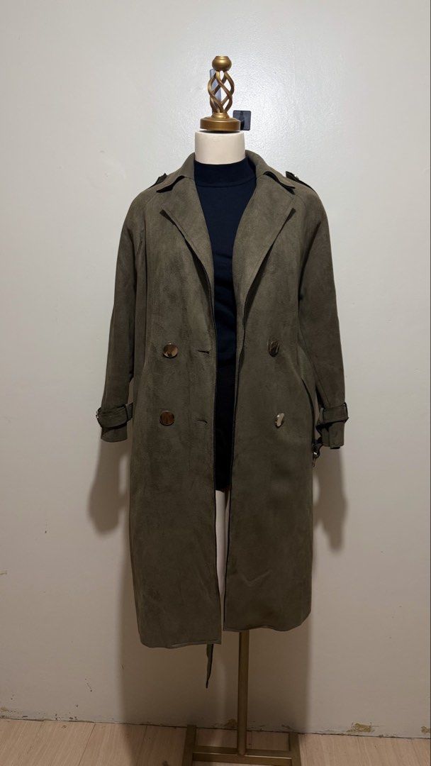 Olive Green Suede Belted Trench Coat (Category: Coats, Jackets and Outerwear) located in Lingayen. Submitted by eunicavena68844 (Listing ID 1464492394, Image 1). Description: Olive green trench coat with belt, double-breasted buttons & adjustable cuffs. Suede-like finish. Wore this in Taiwan and still in good condition. Perfect for cold-weather trips / classy OOTDs..