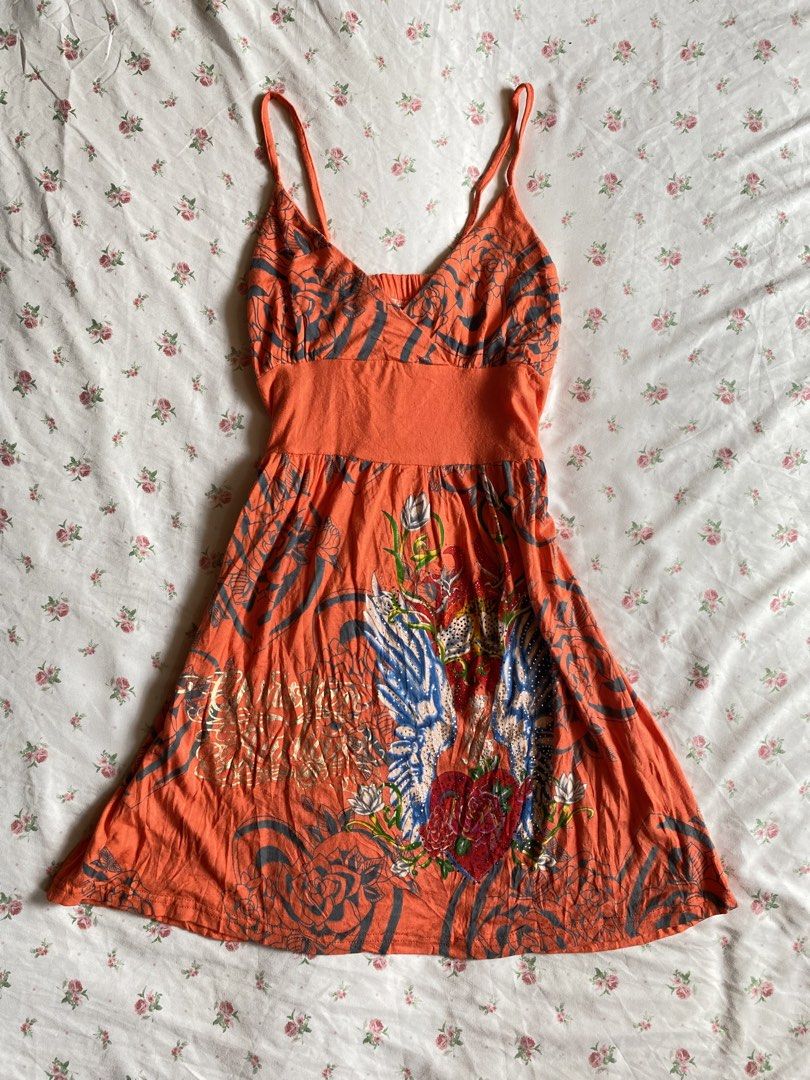 Orange Floral Print Spaghetti Strap Mini Dress (Category: Dresses) located in Iloilo. Submitted by kumiyuiz (Listing ID 1464493346, Image 1). Description: - Vibrant orange mini dress - Unique floral and wing print - Flattering empire waist - Adjustable spaghetti straps - Comfortable fabric with slight stretch - Ideal for casual outings or beach days.