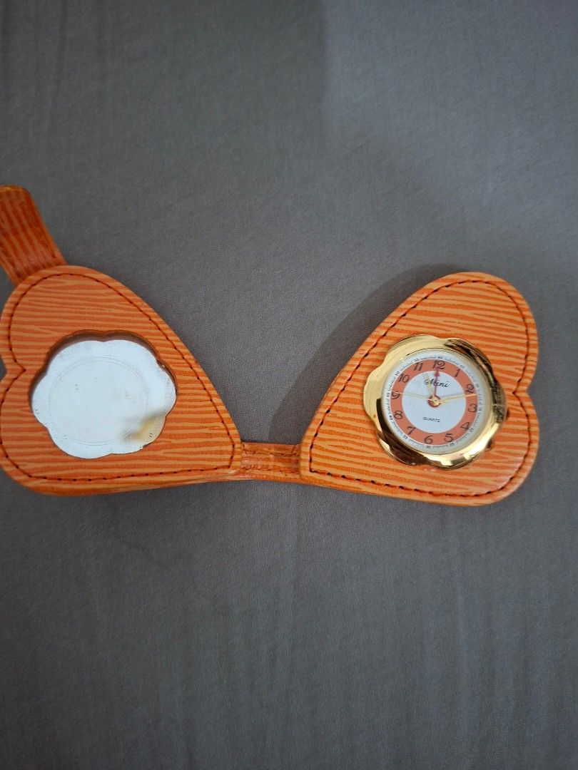 Orange Heart Compact Mirror with Quartz Watch (Category: Makeup) located in Paranaque City. Submitted by maikopaulino1118 (Listing ID 1464515447, Image 1). Description: - Adorable orange heart-shaped compact mirror. - Features a small, functional quartz watch with a white face and gold trim. - Round mirror inside. - Ideal for carrying in your purse or for travel. - A unique and charming accessory..