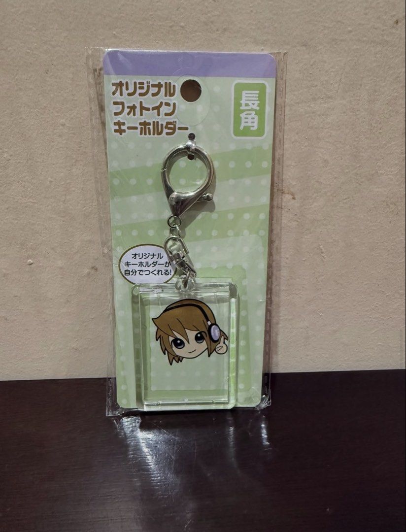 Original Photo Keychain with Anime Character (Category: Character Goods) located in Pasig City. Submitted by boredtakoyaki (Listing ID 1464375531, Image 1). Description: - Adorable anime character design - Features a character wearing headphones - Brand new, in original packaging - Perfect for personalizing bags, backpacks, or keys - A fun and stylish accessory for anime lovers and fans of cute designs - Easy to attach and secure to your belongin