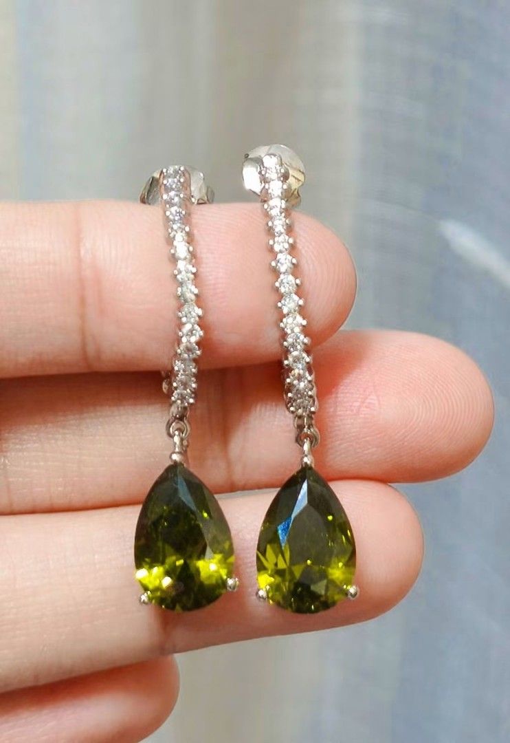 Pear Drop Dangle Earrings with Cubic Zirconia (Category: Earrings) located in Quezon City. Submitted by gemaicloset (Listing ID 1464450326, Image 1). Description: - Beautiful pear-shaped green stone drop earrings - Accented with sparkling cubic zirconia stones - Silver-tone metal - Lightweight and comfortable for all-day wear - Secure post backing - Perfect for adding a pop of color to any outfit.