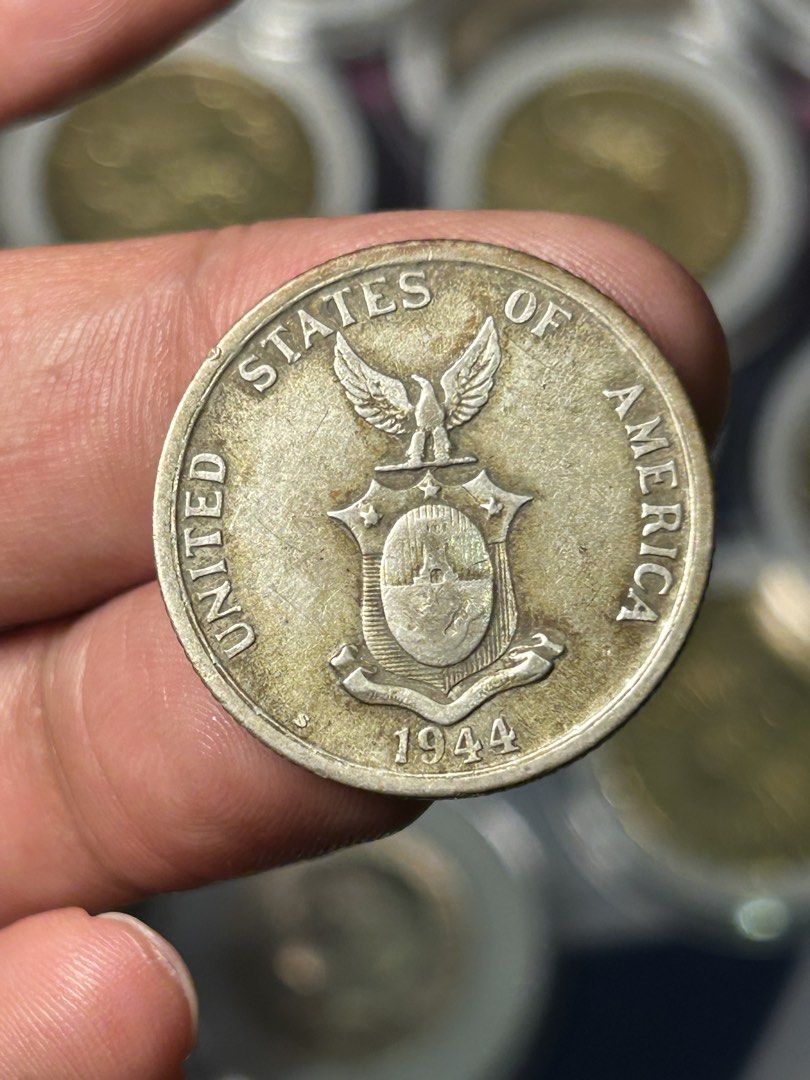Philippines: 1944-S 50 Centavos (Category: Currency) located in Iloilo. Submitted by jackpot.treasures (Listing ID 1464358371, Image 2). Description: - Authentic 1944 Philippines 50 Centavos coin - Features the United States of America emblem - Reverse side depicts a woman with a hammer -U.S. Administration Commonwealth Issue - A must-have for coin collectors Composition: 75% Silver, 25% Copper (10.0 g)..