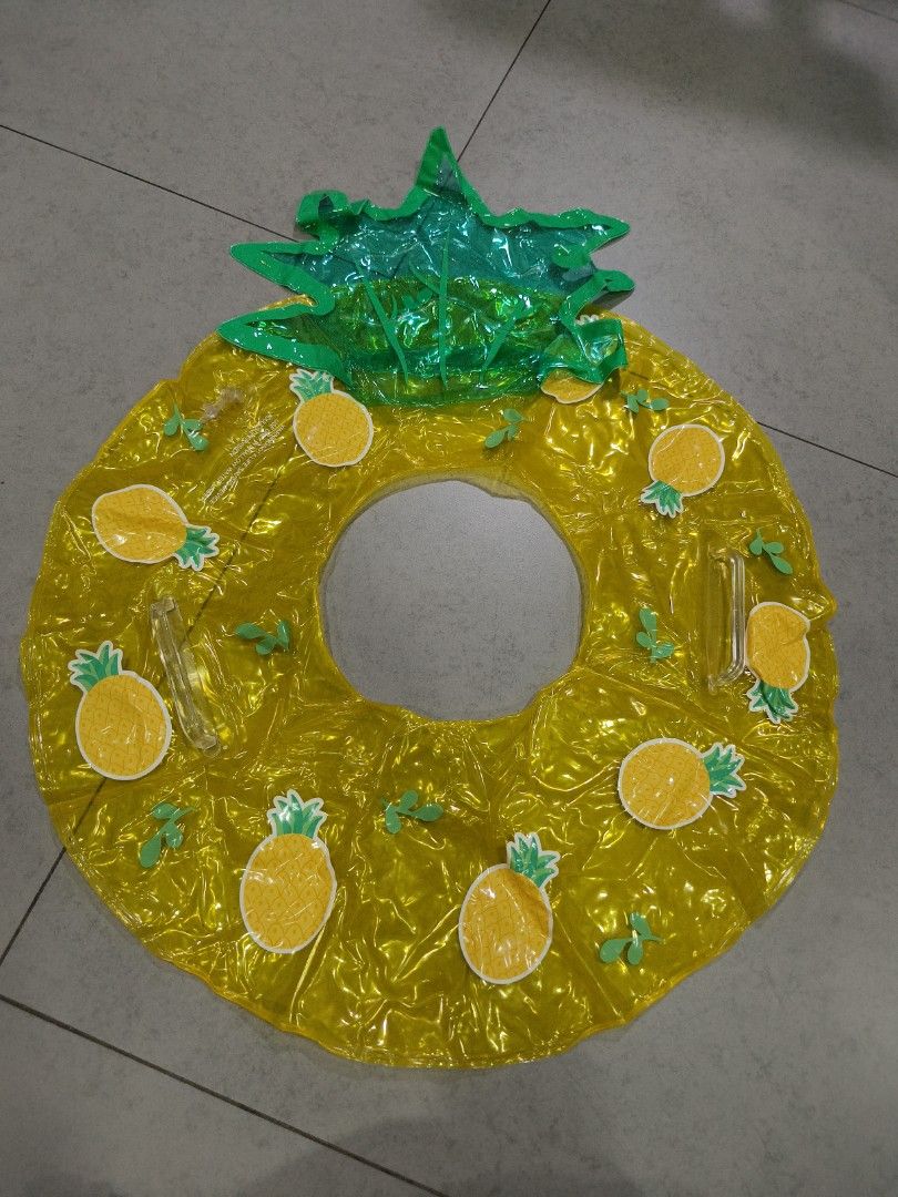 Pineapple Inflatable Pool Float Ring (Category: Kids Toys) located in Singapore. Submitted by securepage77 (Listing ID 1464463239, Image 1). Description: - Fun pineapple-shaped inflatable pool float - Bright yellow with green leafy top - Decorated with smaller pineapple graphics - Ideal for pool or beach use - Easy to inflate and deflate - Perfect for summer fun.