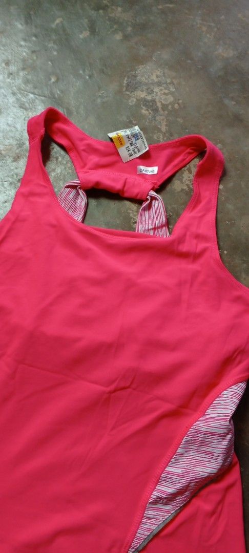 Pink Athletic Tank Top with Built-in Bra (Category: Activewear) located in Manila. Submitted by ezekislacl02490 (Listing ID 1464384992, Image 2). Description: - Vibrant bright pink athletic tank top - Stylish racerback design - Contrasting striped side panels for a sporty look - Built-in bra for added support - Ideal for workouts, running, and other active pursuits - Made with comfortable and breathable fabric.