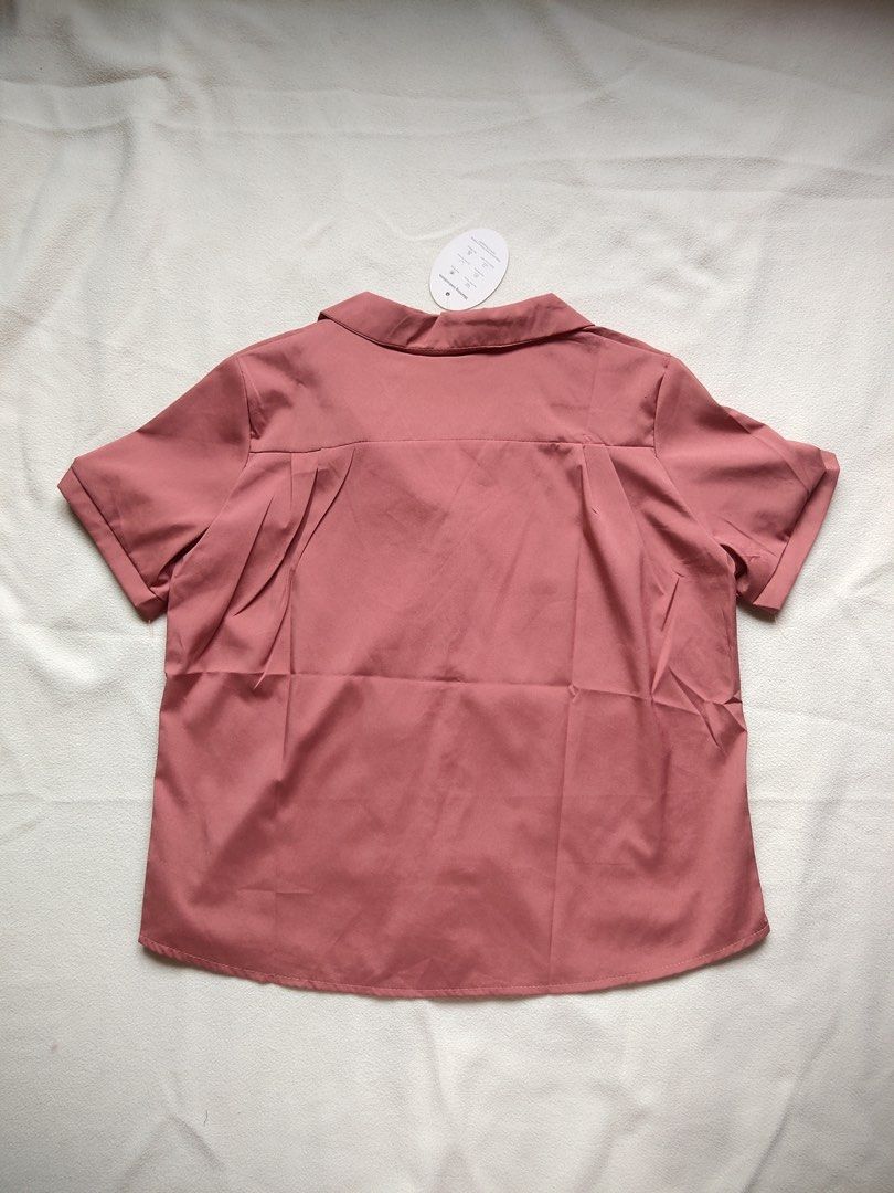 Pink Button-Up Collared Short Sleeve Shirt (Category: Shirts) located in Caloocan City. Submitted by angelinee123 (Listing ID 1464417389, Image 3). Description: Freesize - S to semi L •Payment methods: Gcash (item price + sf) • Payment first policy • Delivery option: - J&t delivery : 2-3 days depends on loc - Lalamove: same day delivery - meetup: 5th avenue lrt station only (cod avail) .