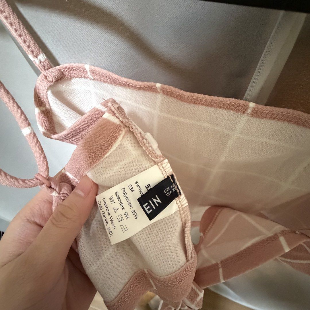 Pink Grid Tie-Back Crop Top (Category: Sleeveless) located in Makati City. Submitted by heyitsg_ (Listing ID 1464420711, Image 3). Description: - Adorable pink crop top with a chic white grid pattern. - Features adjustable straps for a perfect fit. - Convenient tie-back closure. - Versatile for casual outings or stylish evenings..