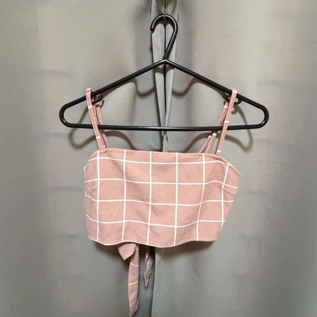 Pink Grid Tie-Back Crop Top (Category: Sleeveless) located in Makati City. Submitted by heyitsg_ (Listing ID 1464420711, Image 1). Description: - Adorable pink crop top with a chic white grid pattern. - Features adjustable straps for a perfect fit. - Convenient tie-back closure. - Versatile for casual outings or stylish evenings..