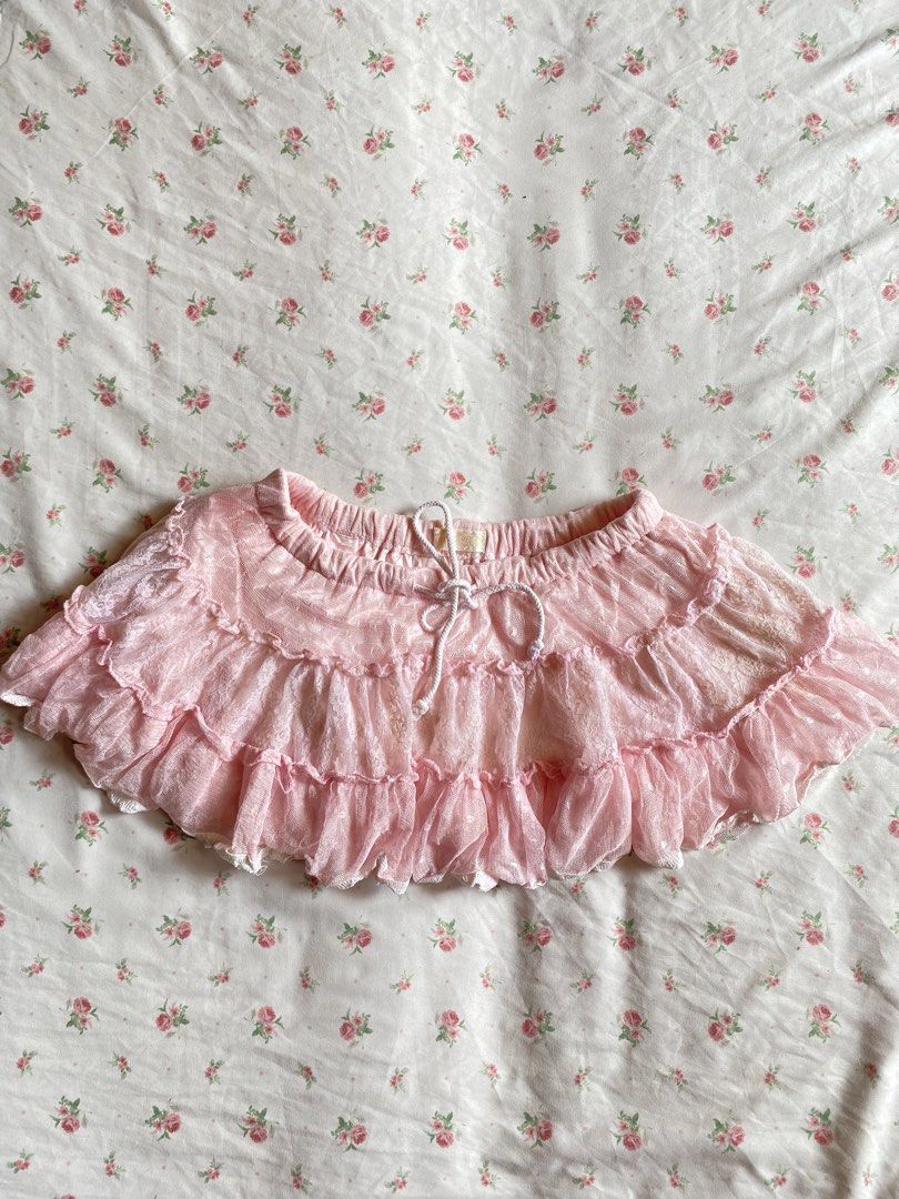 Pink Ruffle Lace Skirt with Drawstring Waist (Category: Skirts) located in Iloilo. Submitted by kumiyuiz (Listing ID 1464493148, Image 1). Description: - Adorable pink lace skirt - Features multiple ruffles and lace trim - Comfortable elastic waistband with a white drawstring - Includes a satin lining for a smooth feel - Ideal for achieving a sweet or cottagecore aesthetic - A fun and flirty addition to your wardrobe.