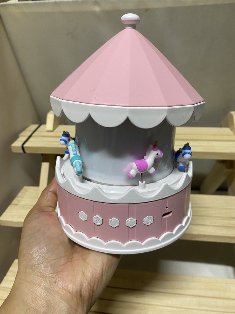Pink Unicorn Carousel Music Box with Lights (Category: Kids Toys) located in Pasacao. Submitted by wengpullar37205 (Listing ID 1464525570, Image 2). Description: - Cute pink carousel music box - Features charming little unicorns - Lights up when turned on - Plays music - Comes with a pack of black masks - Ideal for decoration or as a gift - Measures about [insert measurement if known].