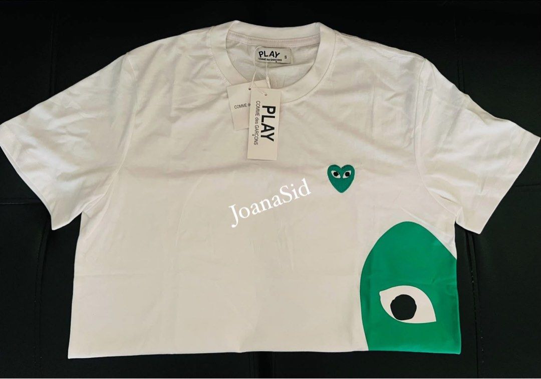 PLAY COMME des GARÇONS White T-shirt (Category: Shirts) located in Lingayen. Submitted by jjsid (Listing ID 1464514405, Image 2). Description: - Brand new PLAY COMME des GARÇONS white t-shirt - Features the iconic green heart logo - 100% Cotton, made in Vietnam - Size: S on tag (fits until semi-large since big po ang sizing nito) - Measurements: Pit to pit approx. 19 inches, length approx. 26 inches - Comes with original tags ✨measurements are pr