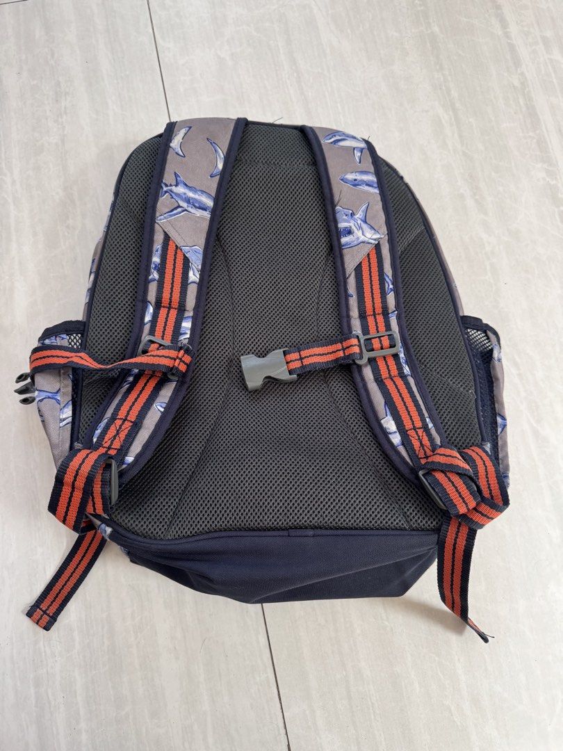 Pottery Barn Kids Shark Print Backpack (Category: Babies & Kids Fashion) located in Makati City. Submitted by kdl123 (Listing ID 1464368065, Image 2). Description: - Fun grey backpack with a playful shark print. - Navy blue base and straps for a classic look. - Accented with orange and navy stripes. - Convenient mesh side pockets for water bottles. - Padded back and shoulder straps ensure comfort. - All zippers are in good working condition. - Id