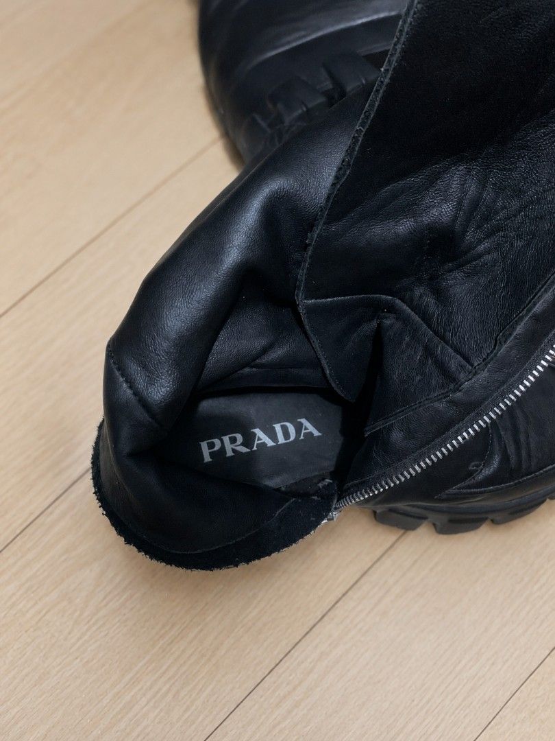 Prada Black Leather Lace-Up Chunky Platform Boots (Category: Boots) located in Manila. Submitted by dizonnixni94357 (Listing ID 1464472303, Image 2). Description: - Genuine black leather Prada boots - Knee-high design - Lace-up front and side zipper for adjustable fit - Chunky platform sole for added height and style - Authentic Made in Italy craftsmanship - Ideal for creating a statement outfit.