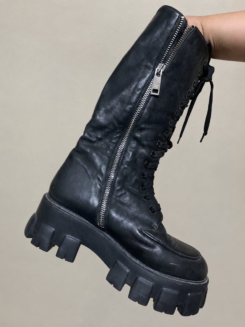 Prada Black Leather Lace-Up Chunky Platform Boots (Category: Boots) located in Manila. Submitted by dizonnixni94357 (Listing ID 1464472303, Image 3). Description: - Genuine black leather Prada boots - Knee-high design - Lace-up front and side zipper for adjustable fit - Chunky platform sole for added height and style - Authentic Made in Italy craftsmanship - Ideal for creating a statement outfit.