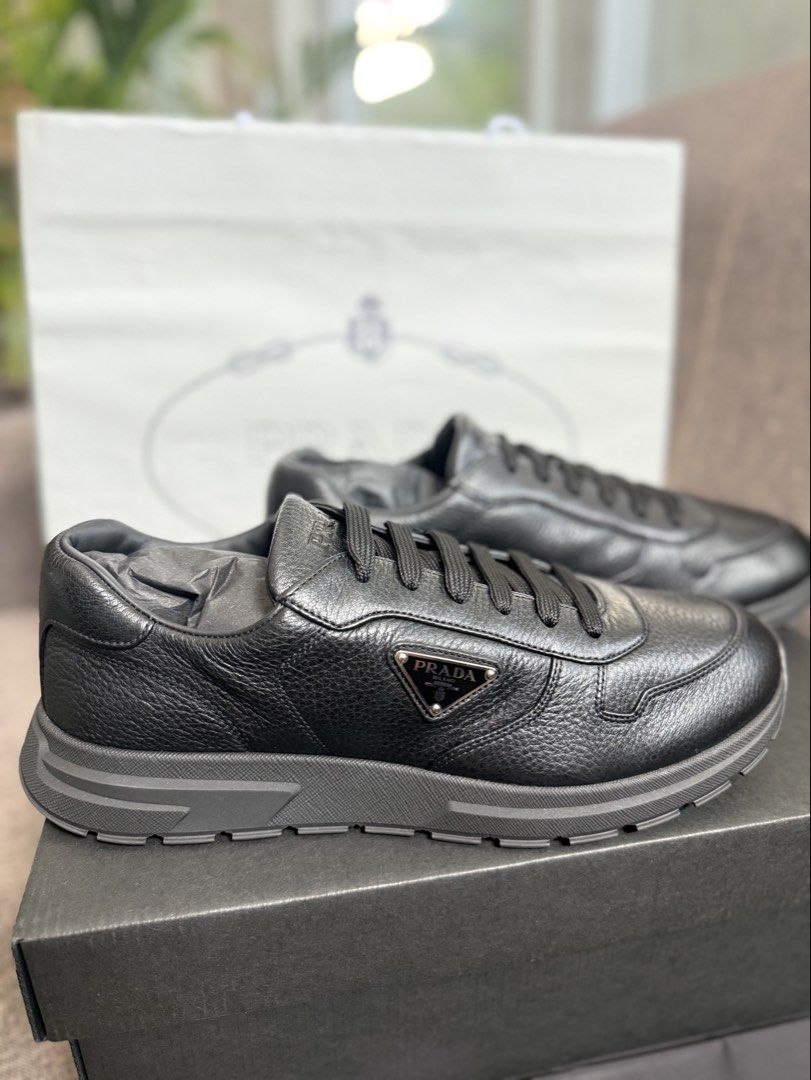 Prada Black Leather Sneakers (Category: Sneakers) located in Las Pinas. Submitted by mitchy.ness (Listing ID 1464481911, Image 2). Description: - Authentic Prada sneakers - Black leather - Iconic Prada triangle logo on the side - Comfortable and stylish chunky sole - Comes with original box, dust bag, and authenticity card - Ideal for casual wear.