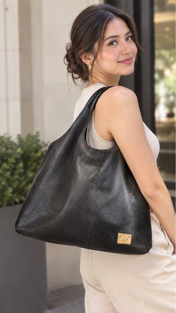 Preloved Anne Klein Leather Hobo Bag (Category: Shoulder Bags) located in Imus. Submitted by bagsofblessings24 (Listing ID 1462744110, Image 1). Description: Original Preloved Anne Klein Black Embossed Leather Hobo Shoulder Bag Stylish black hobo bag - Subtle snakeskin embossed texture - Elegant gold-tone hardware - Secure top zipper closure - Multiple interior compartments and a zippered pocket - Ideal for everyday use Minimal hairlines in the l