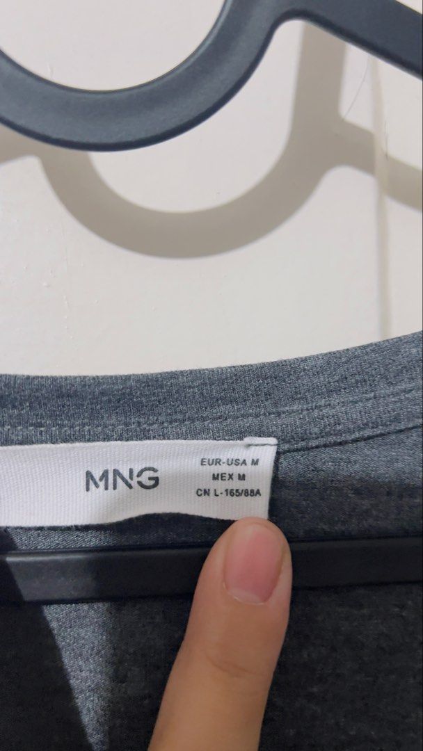 Preloved authentic Mango dark grey V-Neck T-Shirt Size M (Category: Shirts) located in Binan City. Submitted by unicohijoxfudge (Listing ID 1464502324, Image 3). Description: - Basic dark grey v-neck t-shirt - Brand: MNG mango - Features short sleeves with a rolled cuff - Comfortable and versatile for everyday wear - Easy to pair with jeans or shorts - Ideal for casual outings Dimes: 21 inches width x 24 inches height Tags: Burberry Calvin Klein 