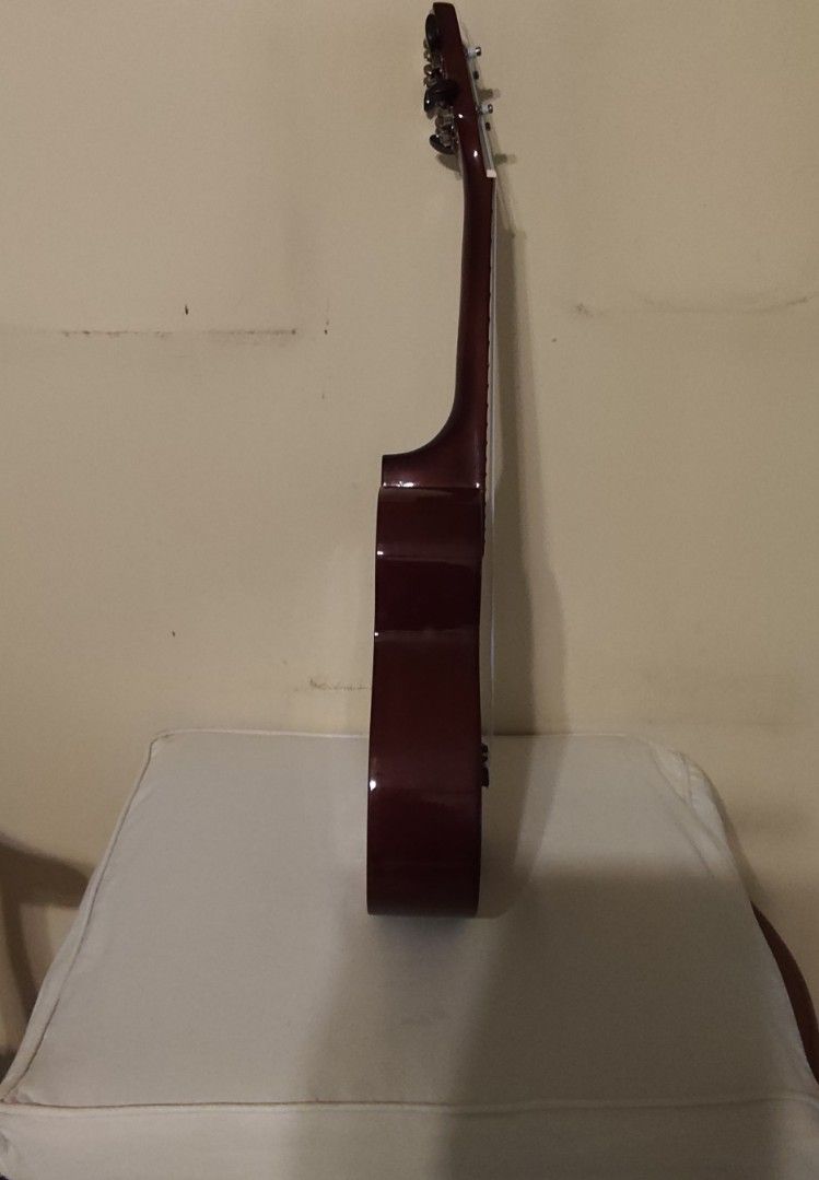 Premiere Ukulele with Gig Bag (Category: Musical Instruments) located in Quezon City. Submitted by mar13.ana.13 (Listing ID 1464412820, Image 3). Description: - Premiere ukulele in a beautiful dark red finish. - Equipped with silver-colored tuners for accurate tuning. - Includes a padded gig bag for protection and easy transport. - Worn out gig bag - Ideal for beginners and aspiring ukulele players..