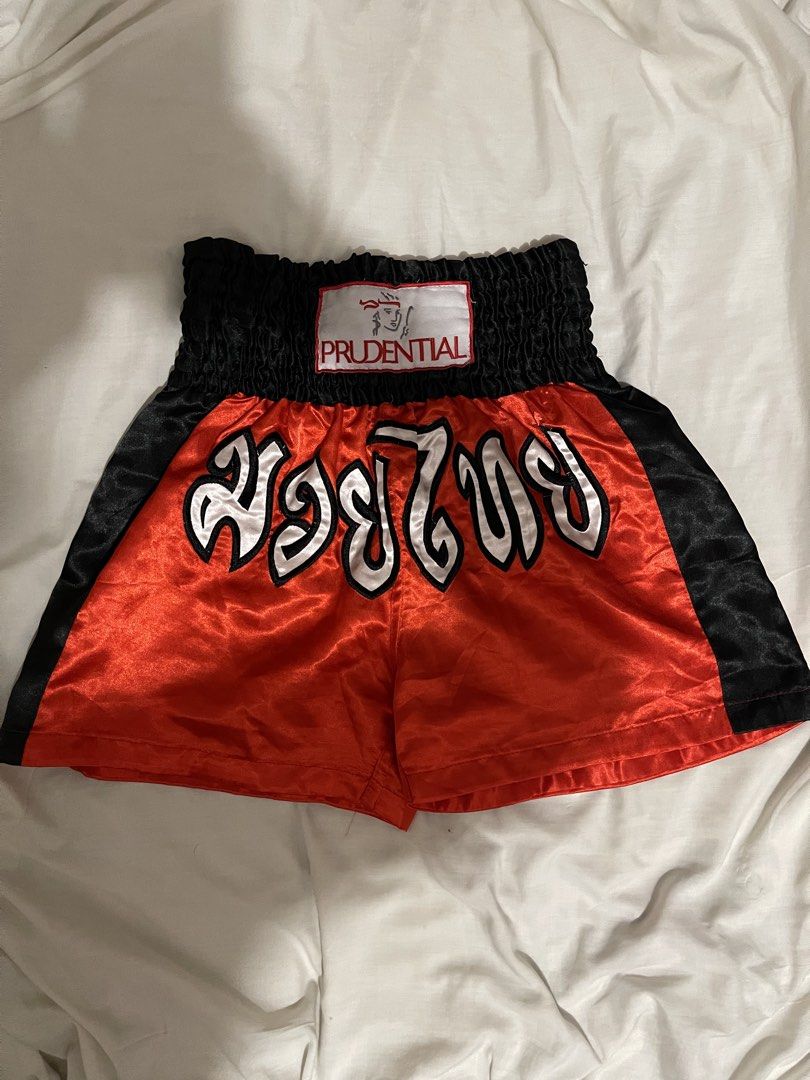 Prudential Muay Thai Boxing Shorts Red Black (Category: Shorts) located in Makati City. Submitted by afterpiece (Listing ID 1464481399, Image 1). Description: Red and black Muay Thai shorts with elastic waistband and Thai writing. Perfect for training. fits 26-30, exact measurements on photos. issue: small loose threads on some parts, you can remove it with a lighter..
