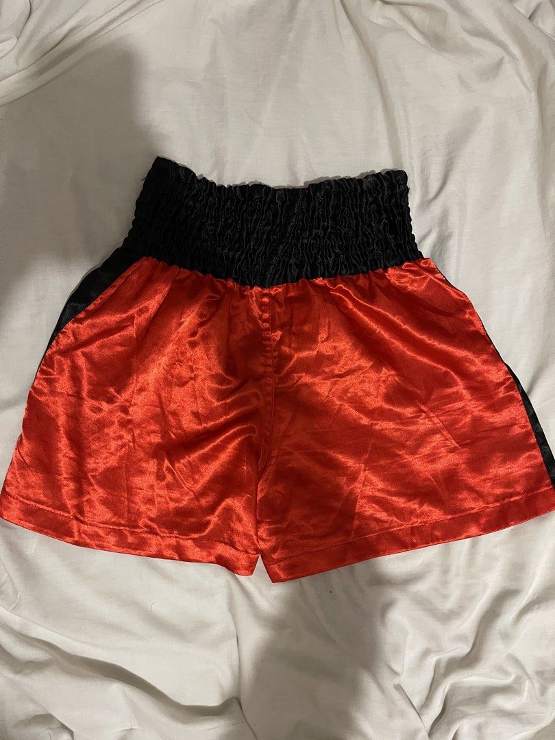 Prudential Muay Thai Boxing Shorts Red Black (Category: Shorts) located in Makati City. Submitted by afterpiece (Listing ID 1464481399, Image 3). Description: Red and black Muay Thai shorts with elastic waistband and Thai writing. Perfect for training. fits 26-30, exact measurements on photos. issue: small loose threads on some parts, you can remove it with a lighter..