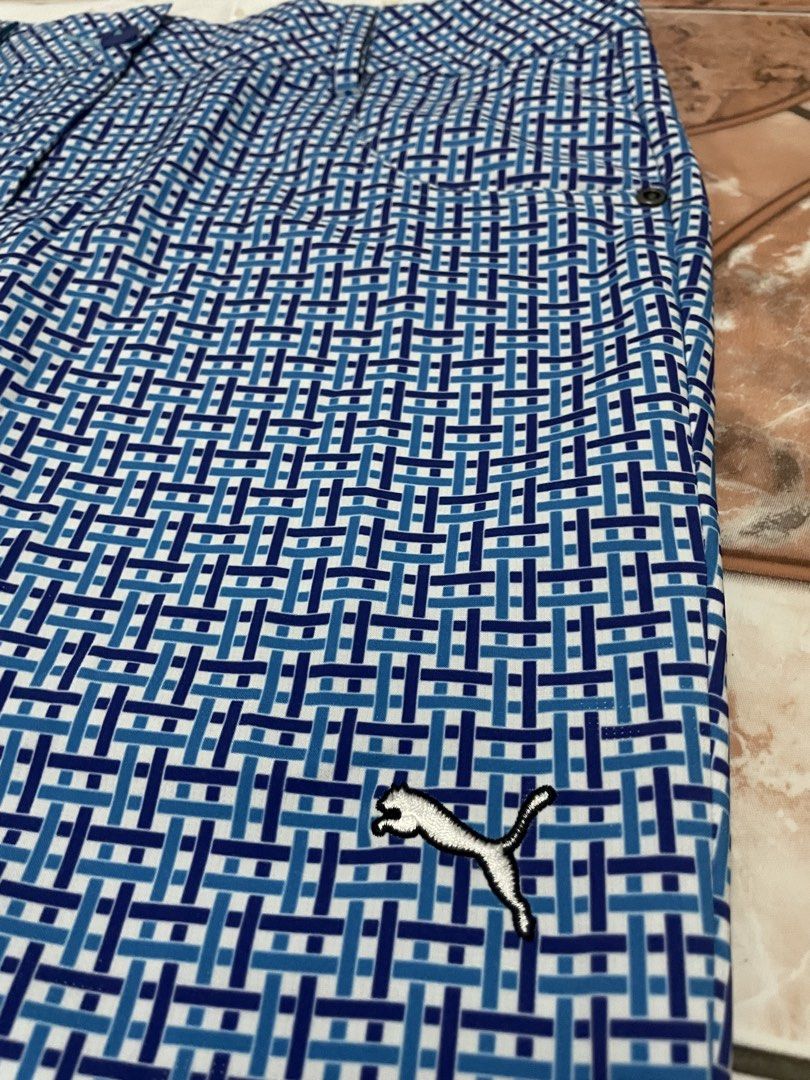 Puma Golf Pants Men's Size 38/10 Blue Patterned (Category: Trousers) located in Guagua. Submitted by 2stephs392 (Listing ID 1464426884, Image 2). Description: - Puma golf pants for men - Stylish cool blue geometric pattern all over - Features functional pockets - Secure button closure - Versatile for golf course or casual outings - Made in Vietnam.