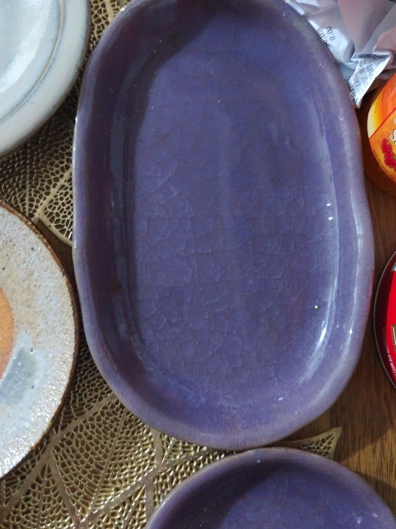 Purple Crackle Glaze Ceramic Oval Dish (Category: Dinnerware & Cutlery) located in Manila. Submitted by marriage031073advocate (Listing ID 1464422346, Image 1). Description: - Lovely purple oval dish - Unique crackle glaze finish - Organic, irregular shape - Ideal for serving small snacks - Doubles as a decorative accent piece - Adds a pop of color to your table - Approximate dimensions: X inches long, Y inches wide.