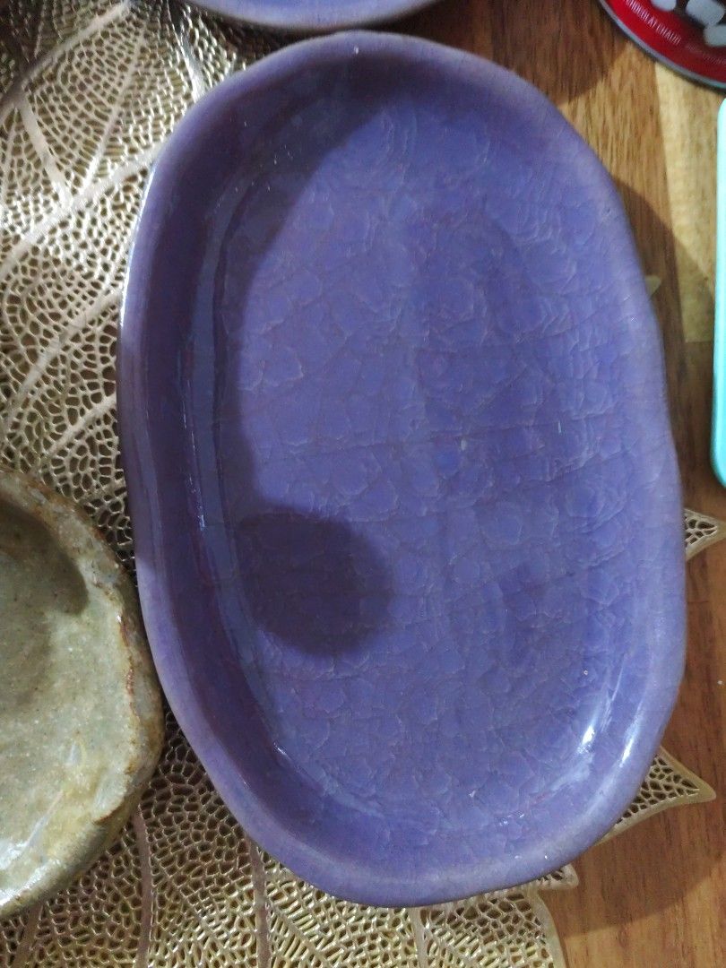 Purple Crackle Glaze Ceramic Oval Dish (Category: Dinnerware & Cutlery) located in Manila. Submitted by marriage031073advocate (Listing ID 1464422346, Image 2). Description: - Lovely purple oval dish - Unique crackle glaze finish - Organic, irregular shape - Ideal for serving small snacks - Doubles as a decorative accent piece - Adds a pop of color to your table - Approximate dimensions: X inches long, Y inches wide.