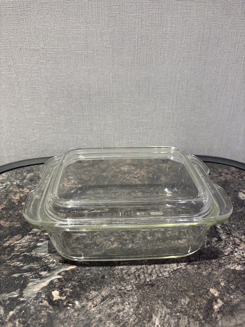 Pyrex Glass Baking Dish with Chipped Lid (Category: Bakeware) located in Manila. Submitted by foundhouseph (Listing ID 1464501604, Image 2). Description: - Pyrex clear glass baking dish - Price: 300php - Includes matching chipped lid - Dimensions: 9 inches (length) x 7 inches (width) x 4 inches (height) - Perfect for baking or food storage - Dishwasher safe - Approximate size: 8x8 inches.