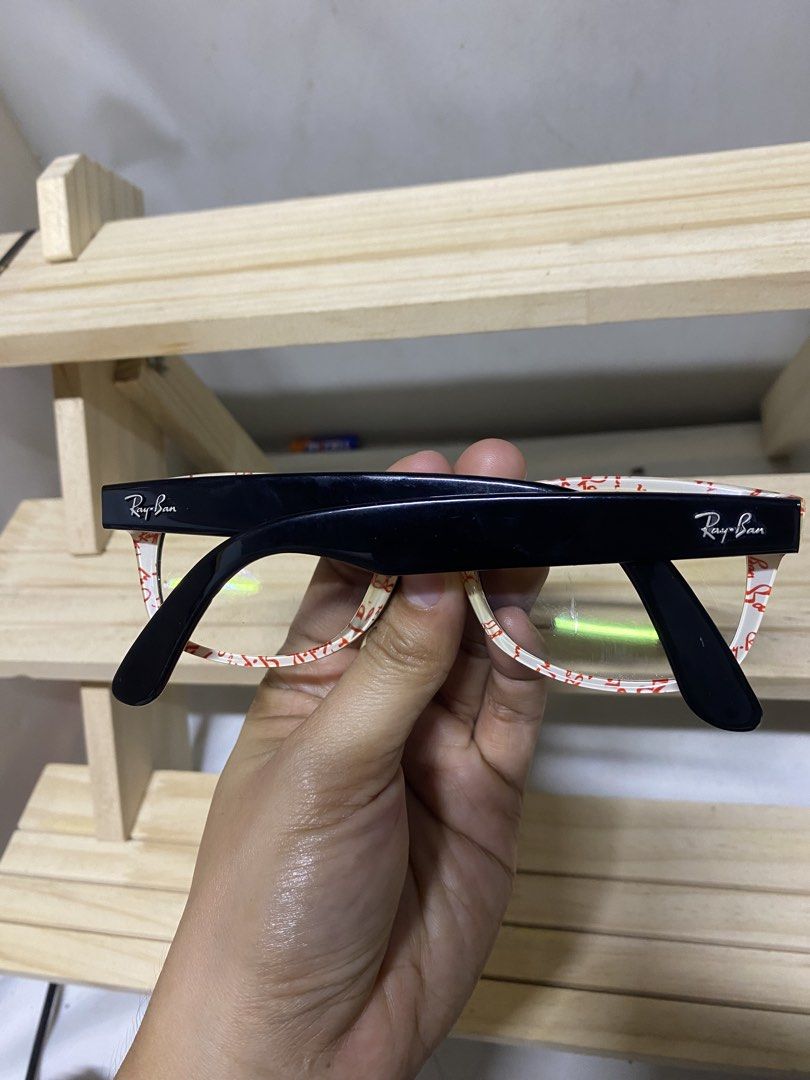 Ray-Ban Wayfarer Eyeglasses Black with Red Logo Pattern (Category: Sunglasses & Eyewear) located in Pasacao. Submitted by wengpullar37205 (Listing ID 1464525233, Image 2). Description: - Classic black Ray-Ban Wayfarer style eyeglasses - Clear lenses - White interior on arms with repeating red Ray-Ban logo pattern - Ray-Ban logo also visible on the outside of the arms - Versatile for everyday wear or as a fashion statement -wala pong grado lense n