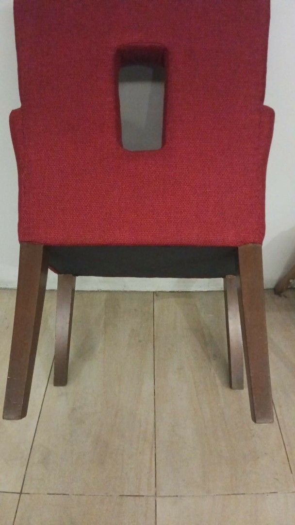 Red Upholstered Armchair with Cutout Back (Category: Chairs) located in Las Pinas. Submitted by jesus1smysavi0r (Listing ID 1464359471, Image 2). Description: - Comfortable armchair with a unique backrest cutout. - Upholstered in a textured red fabric. - Sturdy wooden legs. - Perfect for adding a vibrant accent to any room..